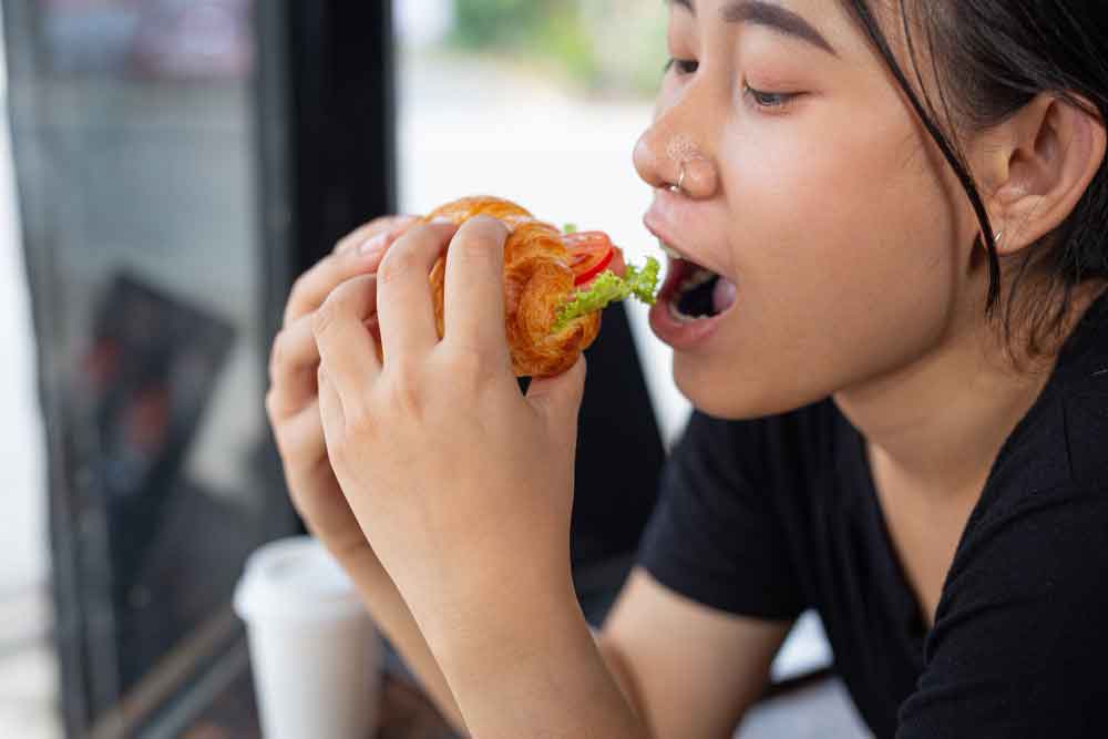 Choking woman while eating food